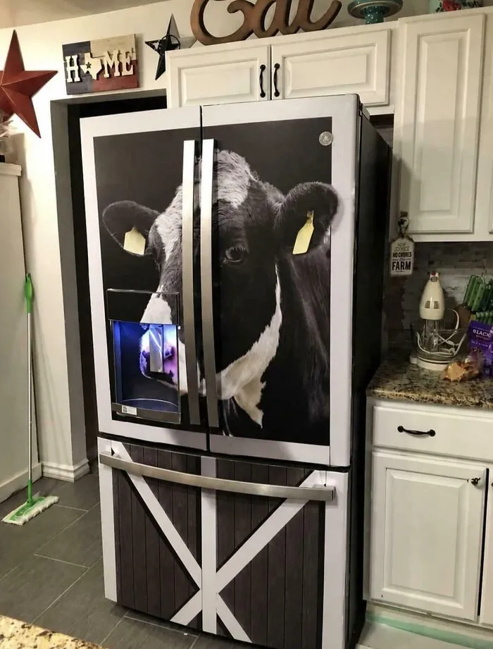 Kitchen refrigerator wrapped with a realistic cow face image houses decor.