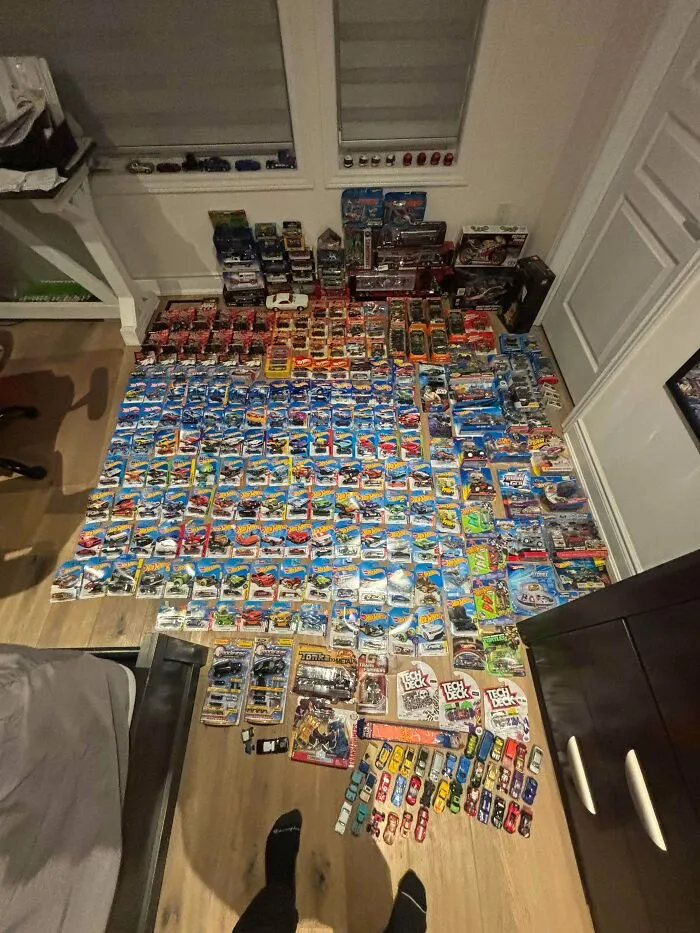 Extensive Hot Wheels car collection found through dumpster diving spread out on floor