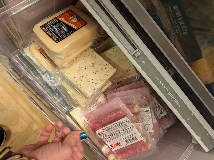 Fresh cheese and meat packages found while dumpster diving inside refrigerator drawer