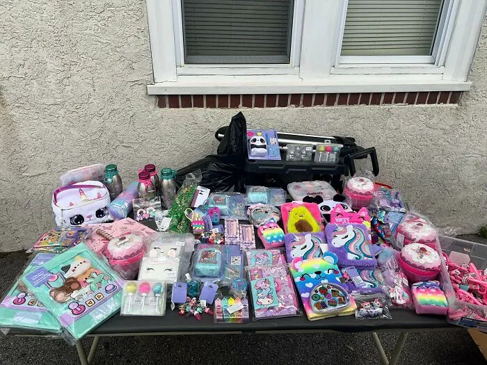 Table full of colorful stationery and toys from dumpster diving finds