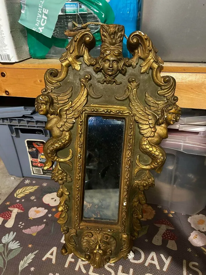 Ornate vintage mirror with mermaid and angel designs found dumpster diving