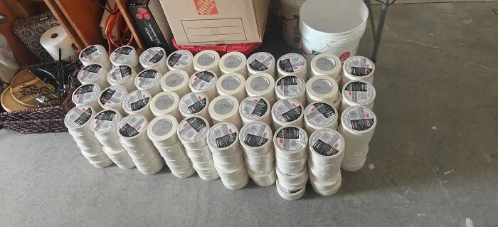 Large collection of unused white tape rolls found while dumpster diving