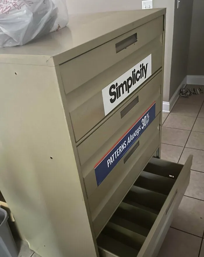 Metal filing cabinet with stickers found during dumpster diving