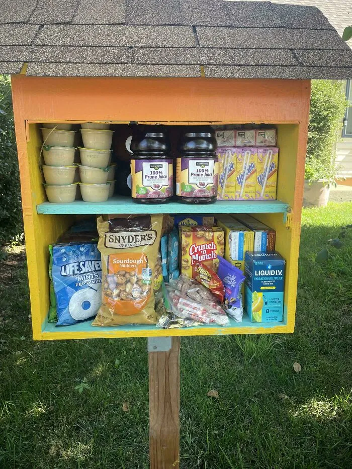 Small food pantry stocked with snacks and drinks found during dumpster diving