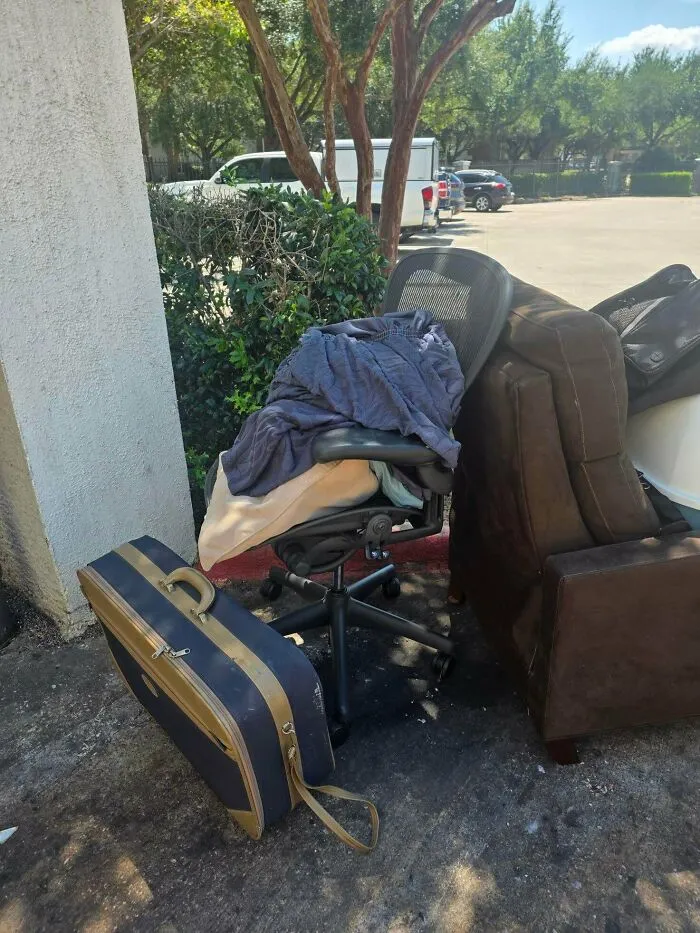 Office chair and suitcase discarded outdoors in dumpster diving find