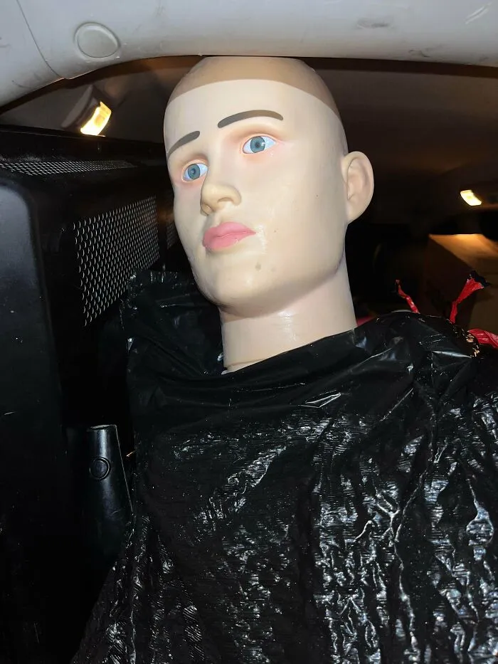 Mannequin head wrapped in black plastic bag found during dumpster diving