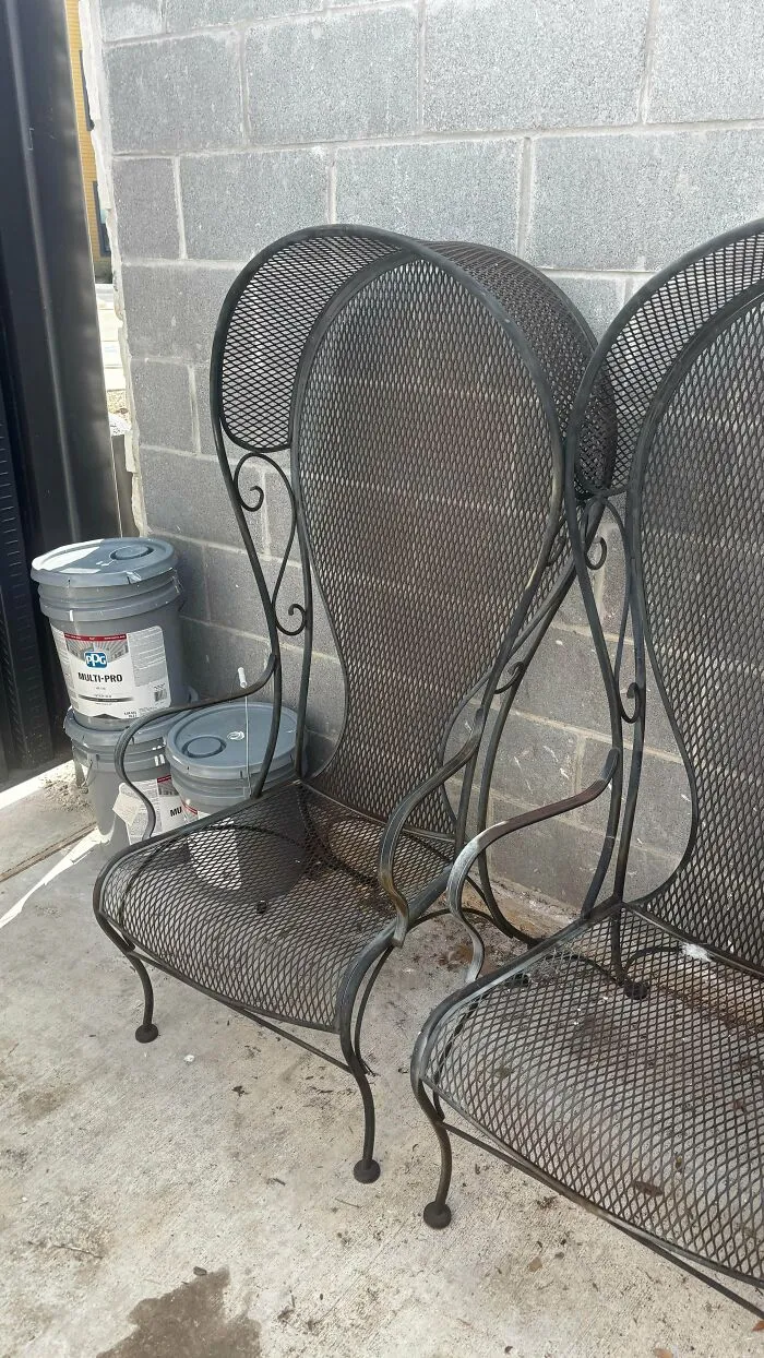 Black metal mesh patio chairs found while dumpster diving