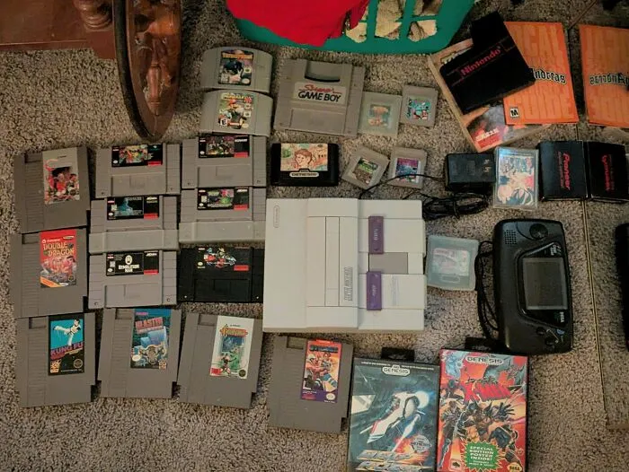 Collection of vintage Nintendo and Sega game cartridges and consoles found dumpster diving
