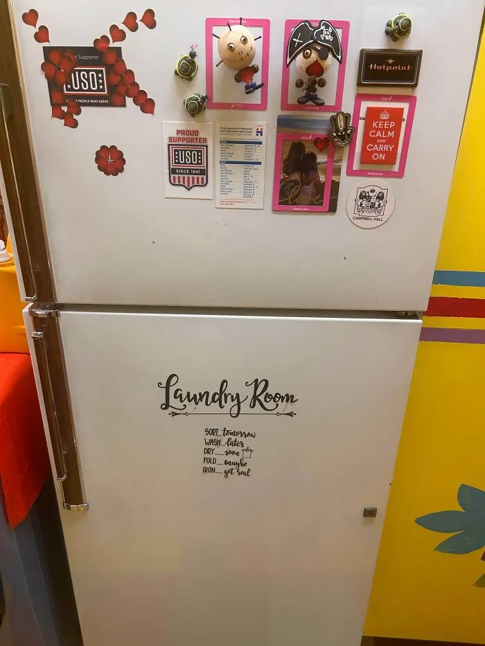Vintage white refrigerator decorated with magnets, showing durable old products still in use after decades.