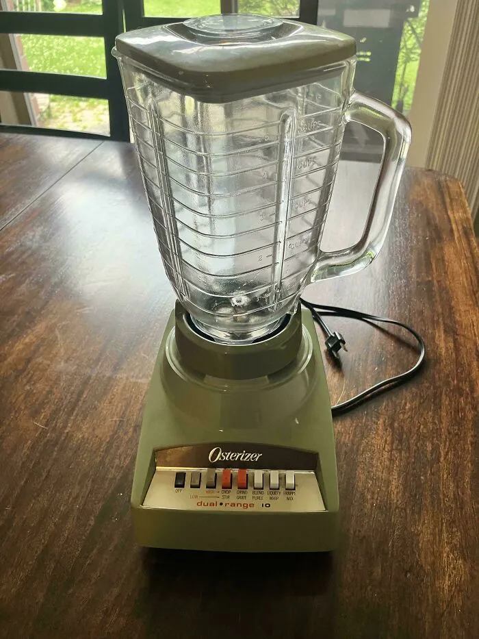 Classic green Osterizer blender on a wooden table, one of many old products that last.