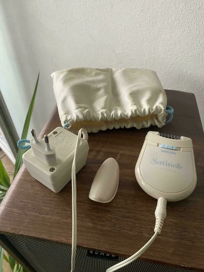 Vintage Philips Satinelle epilator and charger, examples of old products that still function.