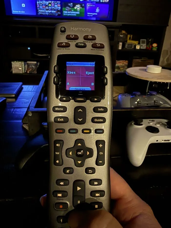Silver Harmony universal remote control held in hand, representing old products that refuse to give up.