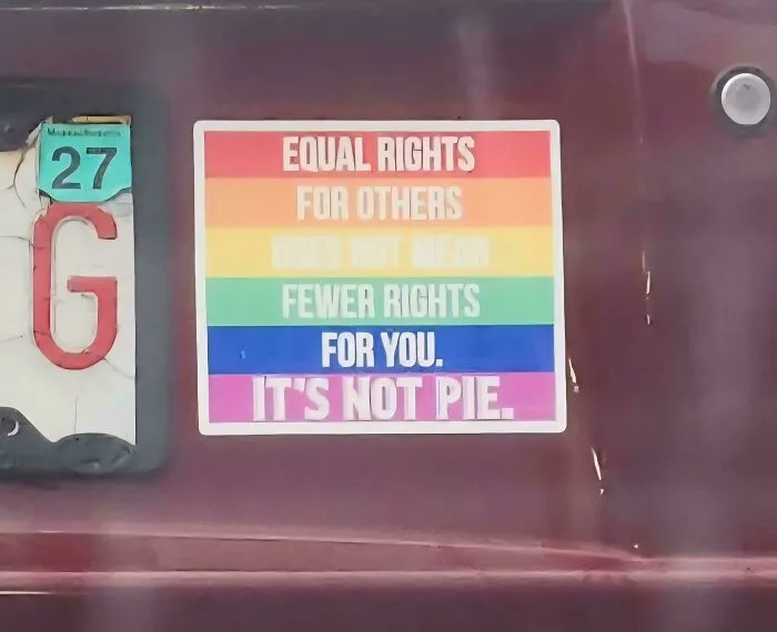 A rainbow bumper sticker with a message about equal rights on a vehicle.