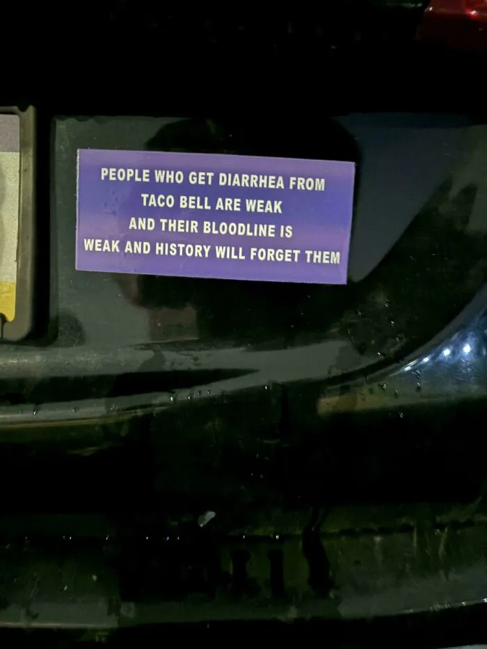 A purple wild bumper sticker on a vehicle with humorous text about Taco Bell and weak bloodlines.