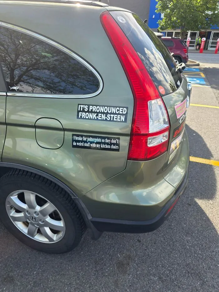 Green SUV with movie quote bumper decals, showing unique and wild bumper stickers.