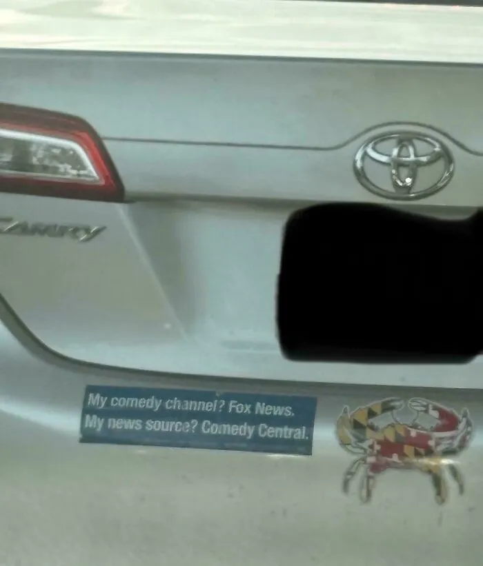 A humorous bumper sticker on a car stating My comedy channel? Fox News. My news source? Comedy Central.