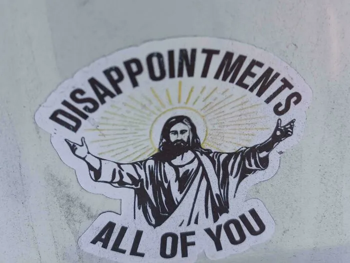 An illustration sticker of Jesus with funny text saying DISAPPOINTMENTS ALL OF YOU.