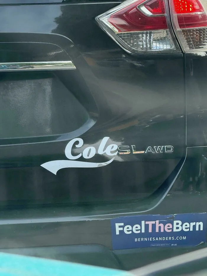 Custom Coleslaw bumper stickers combining Cole sticker and car logo on a black vehicle.