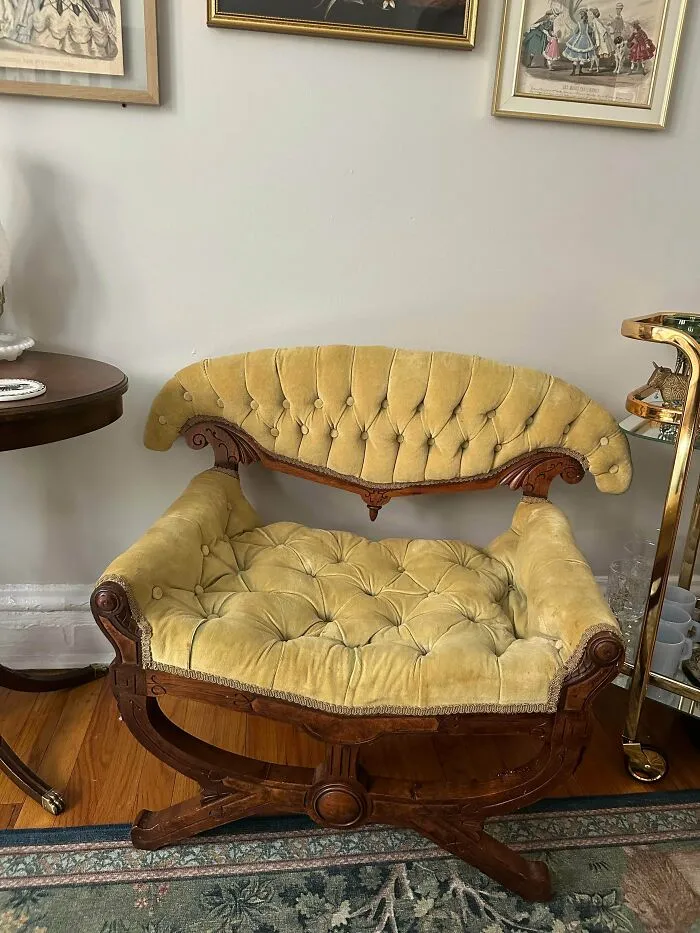 A vintage yellow tufted velvet chair representing old treasures for antique lovers