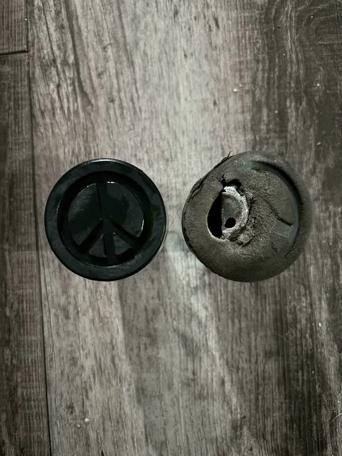 Comparison of a new peace sign rubber grip and a completely worn-out one showing how time slowly reshapes objects