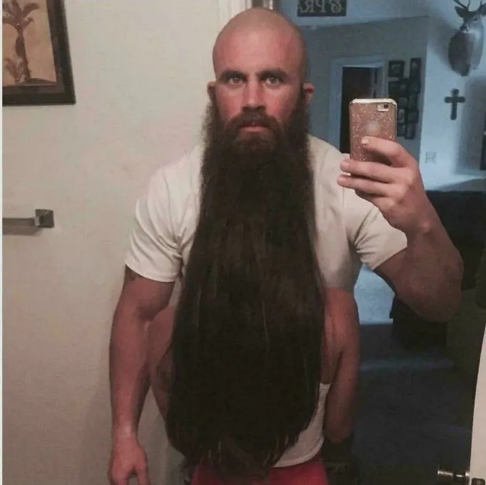 Man with long beard disguising person behind creating eye confusing photo