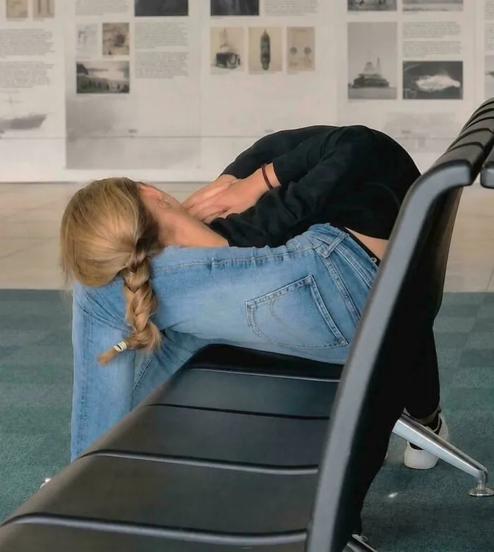 Person folded in awkward yoga pose on bench confusing the eye