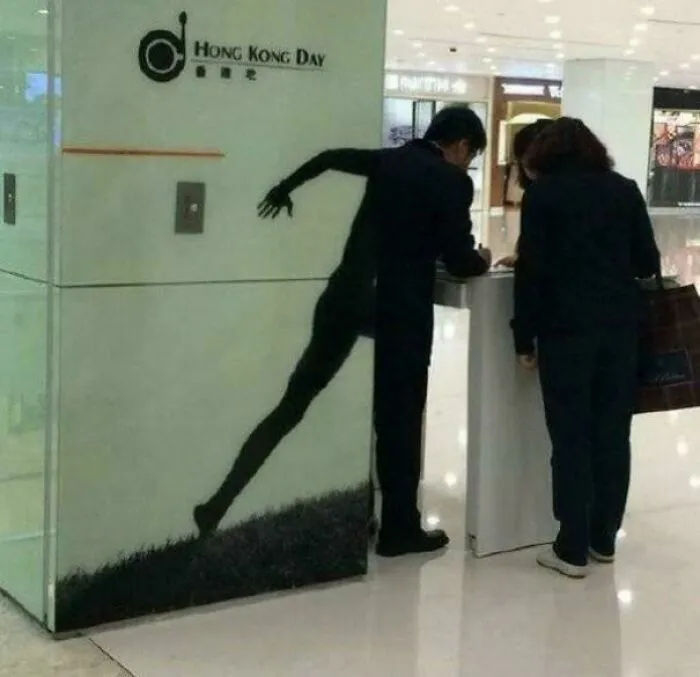 Shadow art creates illusion of a man with elongated limbs