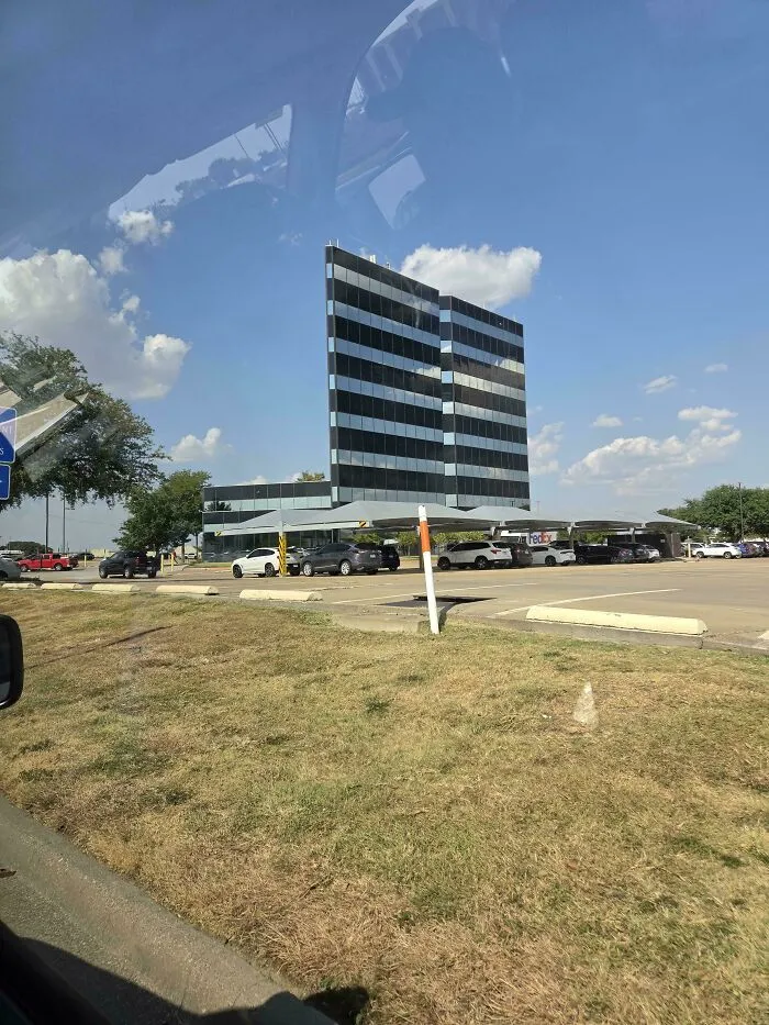 Building appears floating supported by cars in optical illusion