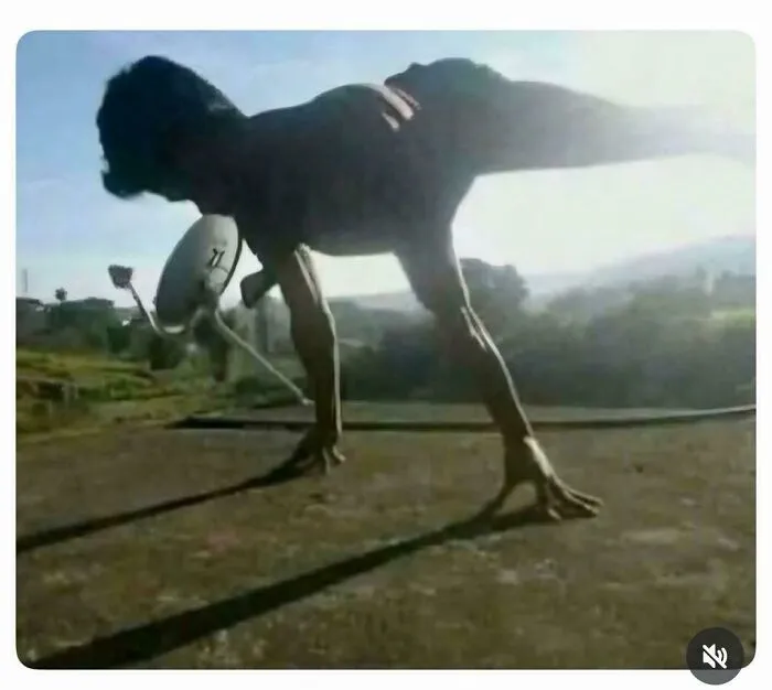 Man balancing on one hand with body casting shadow creating a strange visual illusion