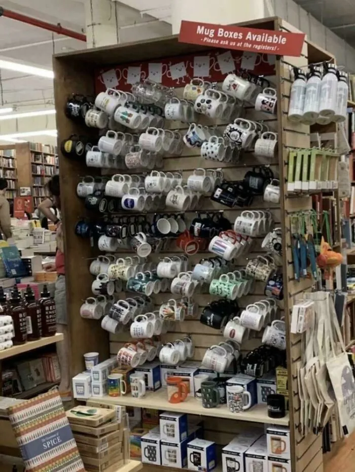Mugs hanging on shelves creating a confusing visual display in store