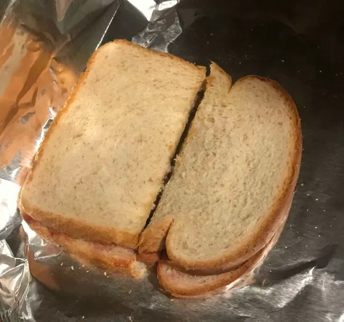 A sandwich cut in an odd, uneven shape, showing one of the ridiculous things wives do.