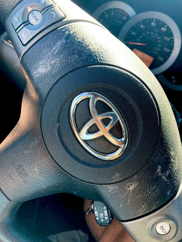 Dirty steering wheel showing sunscreen marks, depicting unhinged things wives do.