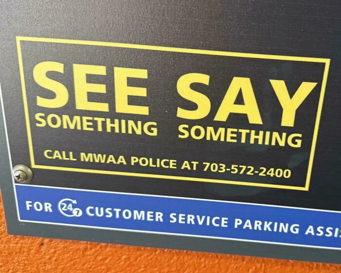 A poorly formatted sign reading SEE SAY SOMETHING SOMETHING, demonstrating a badly designed sign.