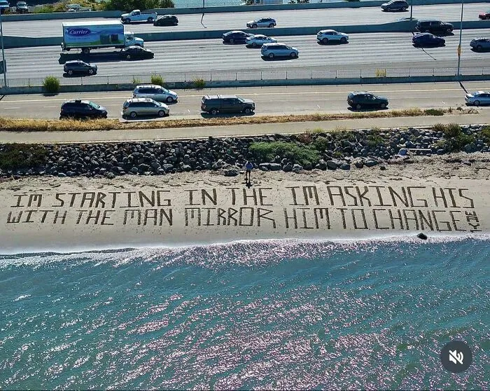 Song lyrics written on the sand showing poorly ordered text and badly designed signs