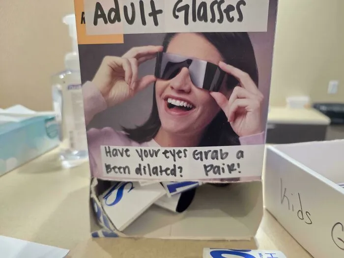 Eyewear display box with confusing handwritten text instructions, an example of hilarious badly designed signs.