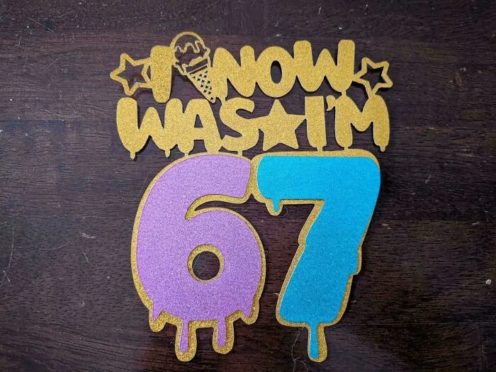 A cake topper with confusing lettering showing badly designed signs