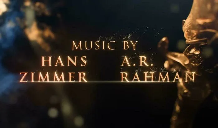 A movie screen credit displaying music by Hans Zimmer and A. R. Rahman showing badly designed text layout