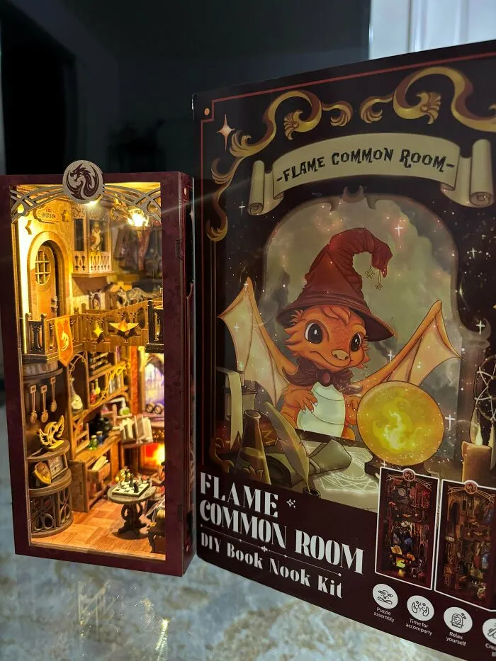 Flame Common Room DIY book nook kit showing a cozy magical library next to its illustrated box