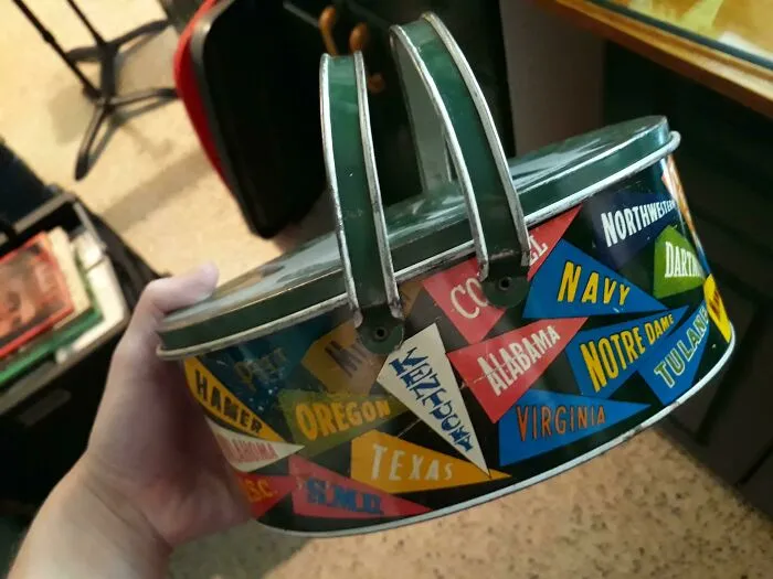 A vintage tin lunch box showing how time slowly reshapes its surface with minor rust and scratches
