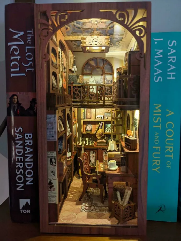 Cozy two-story study room model placed between books as book nooks