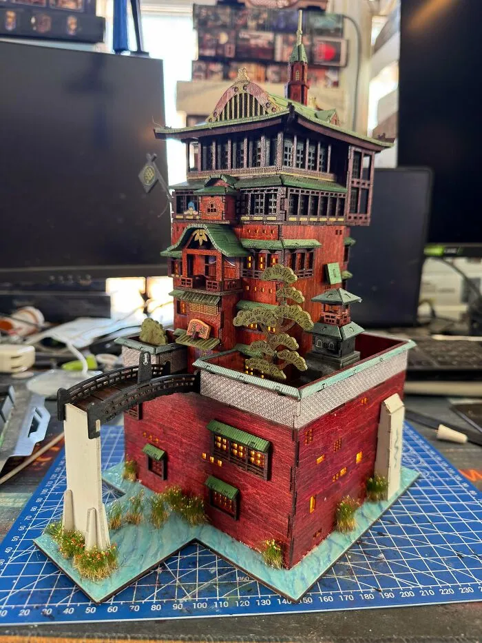 Intricate miniature bathhouse model resembling spirited away book nooks