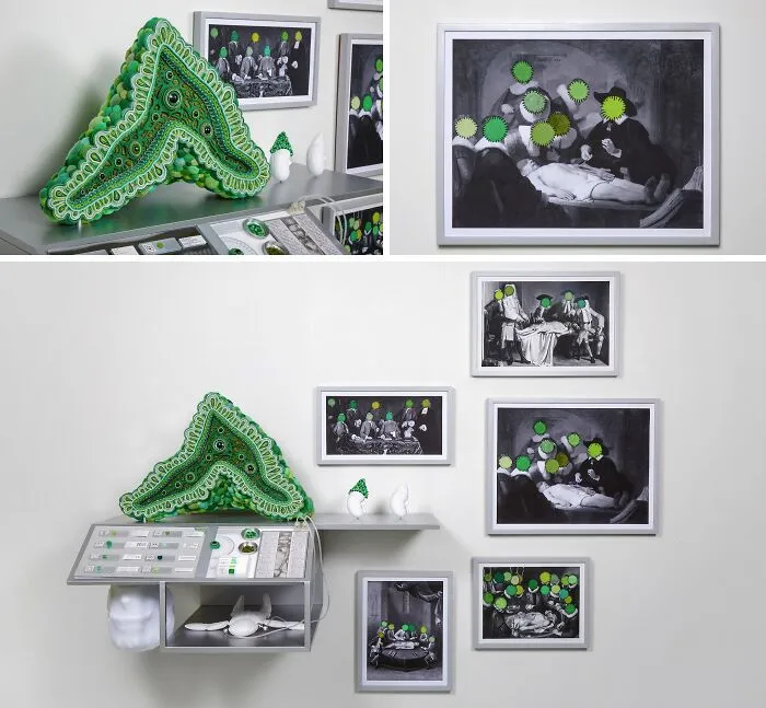 A wall display featuring unusual sculptures and black and white photographs with green face details