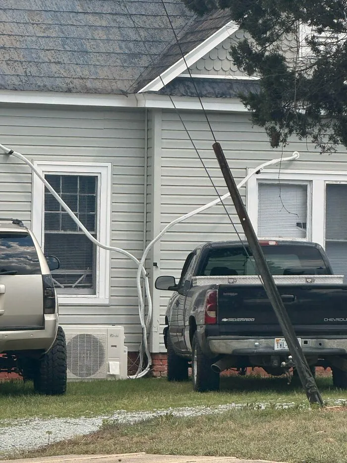 Questionable DIY projects showing long white pipes messy routed along house exterior walls.