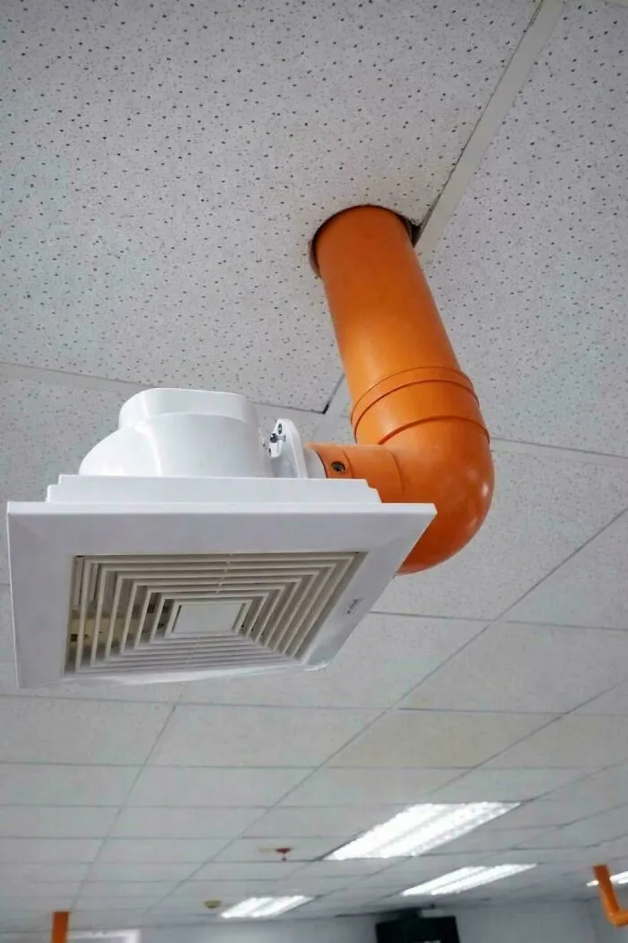 An oddly routed orange ventilation pipe ceiling installation from funny DIY projects.
