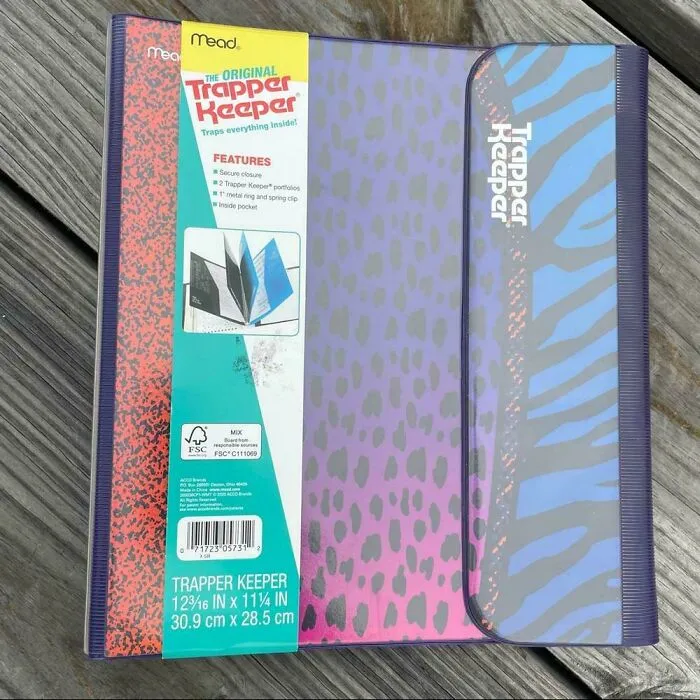 An original purple and blue patterned Mead Trapper Keeper binder on a wooden surface, popular in the 90s.