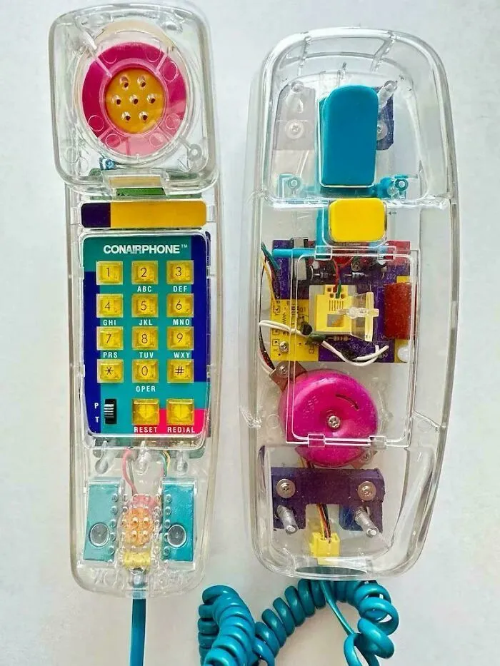 A transparent Conairphone on a wall, capturing retro technology from the '90s