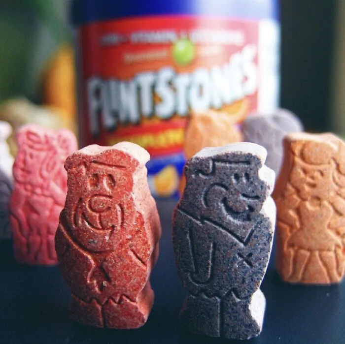 A close-up of colorful Flintstones chewable vitamins, a popular product in the '90s