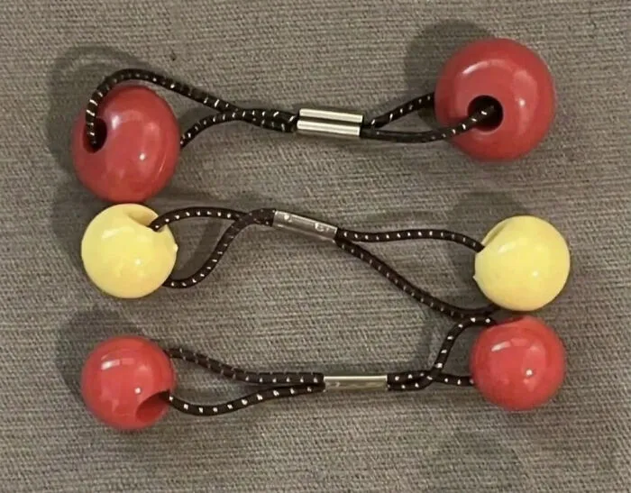 Three vintage elastic hair ties with large plastic beads, a classic hair accessory from the '90s.