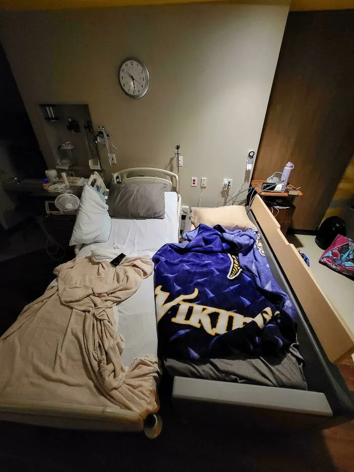 A hospital room setup showing a supportive dad staying near his partner in a wholesome fatherhood moment