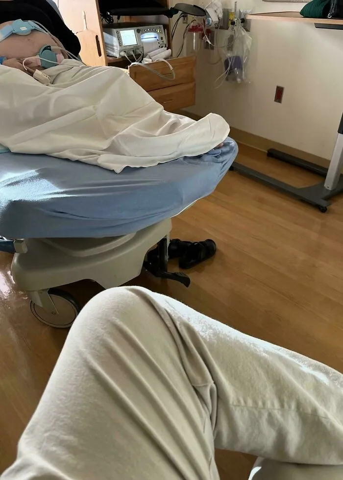 A dad waiting in a hospital room as a sign of wholesome fatherhood support during labor